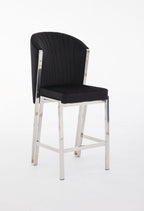 A black bar stool with a upholstered seat and a metal frame.