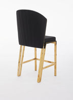 A black upholstered bar stool with a gold metallic frame and a full backrest.