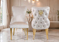 Cream velvet Victoria lion knocker dining chairs with button-tufted back, gold lion ring and gold legs