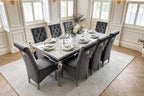 Light grey marble Louis dining table with eight dark grey velvet Sofia lion knocker chairs and chrome legs – luxury dining set UK