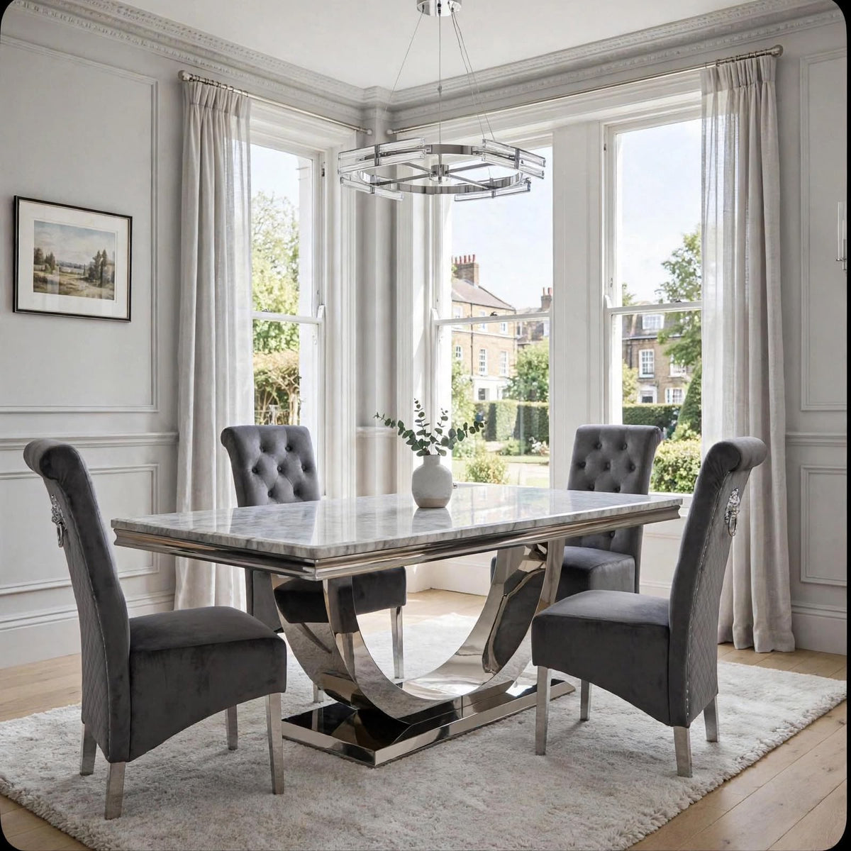 Light grey marble dining table with polished chrome London base and four dark grey velvet Sofia chairs