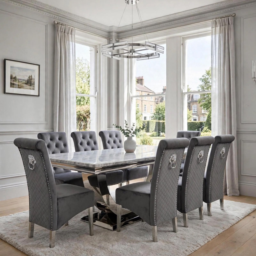 Close-up of dark grey velvet Sofia dining chair beside a light grey marble London table