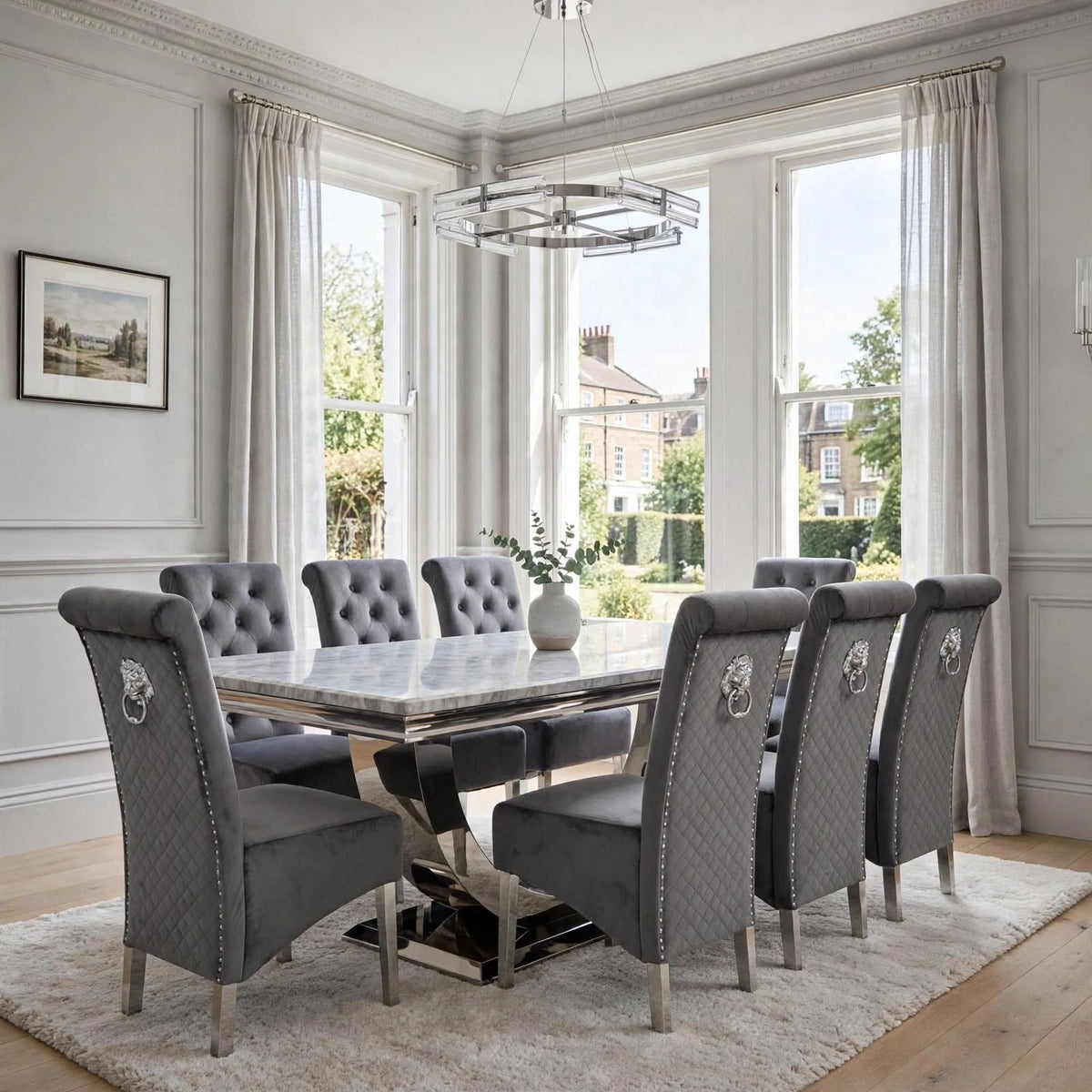 Close-up of dark grey velvet Sofia dining chair beside a light grey marble London table