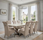 Close-up of mink velvet Sofia dining chair beside a cream marble London table