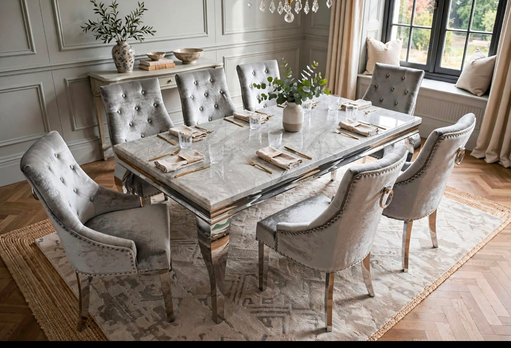 Louis light grey marble dining table with eight silver velvet Jessica chairs with tufted backs on a patterned rug in a classic dining room